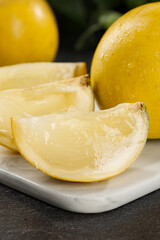 Fresh Honeydew Melon Slices with Juicy Yellow Flesh on White Plate