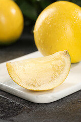 Fresh Yellow Melon Slice with Juicy Crystal Flesh Detail on Cutting Board