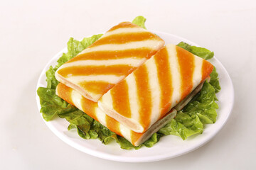 Fresh Marinated Tofu Slices with Orange Glaze on Lettuce Bed - Healthy Vegetarian Protein Dish