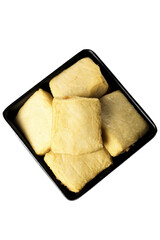 Fresh tofu cubes in black dish for Asian cooking and vegetarian meals