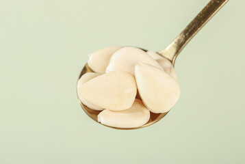 Sweet Peeled Sliced Almonds on Copper Spoon - Healthy Nuts Food Photography Showcase