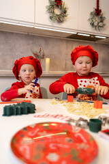 Kids in festive hats create holiday crafts in a cozy kitchen setting during winter season