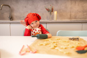 Young chef preparing cookie dough in a modern kitchen during the festive season