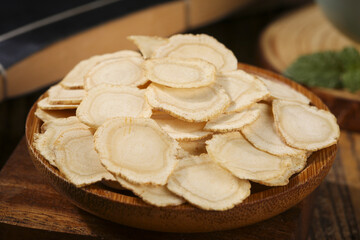Traditional Chinese Ginseng Slices in Wooden Bowl - Natural Herbal Medicine Supplement