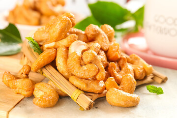 Salted Crispy Vietnamese Cashews with Mint Leaves on Bamboo Spoon - Healthy Roasted Nuts Snack