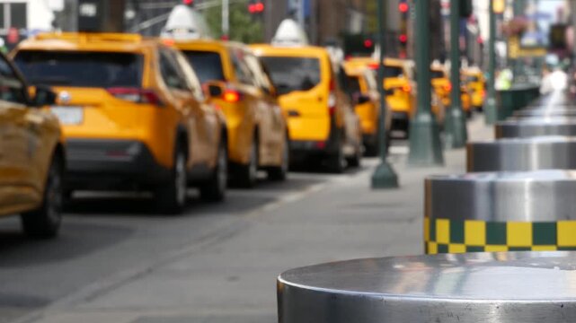 Manhattan Midtown street New York City, United States. Defocused row of yellow taxi cars. Many taxi cabs in line on 8th avenue near Penn Station. Taxi queue, urban road traffic, passenger transport.