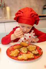 Child decorates gingerbread cookies in bright kitchen during festive holiday season