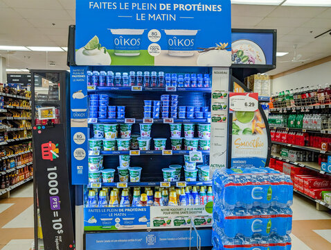 Canada, Quebec, 22 November 2025 : Oikos and Activia yogurt display in a bright grocery store aisle