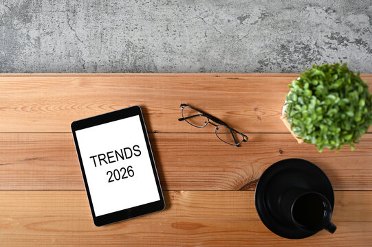 Tablet Displaying Trends 2026 on Wooden Desk &mdash; Business Insight and Creative Workspace Concept