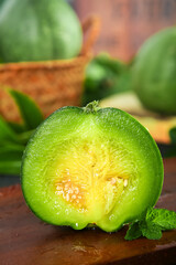 Fresh Honeydew Melon Slice with Green Flesh and Seeds on Wooden Cutting Board