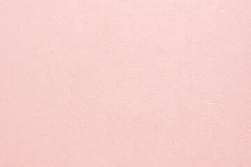 Soft pale pink Japanese washi paper texture background with natural fibers and light diffusion