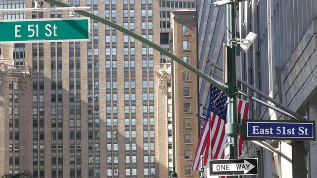 New York City Park Avenue, street sign in Manhattan Midtown, United States. Urban road sign, traffic sign in NYC, USA. Building architecture near Grand Central. One way arrow and American flag.