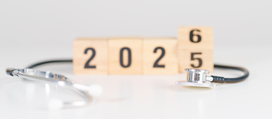 2025 end year to Happy New Year 2026 with Stethoscope of doctor and heart shape on table. health...