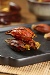 Dried Sichuan Gardenia Fruit Spice on Slate Board - Traditional Chinese Cooking Ingredient