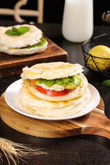 Fresh Layered Flatbread Sandwich with Vegetables and Milk on Rustic Wooden Board