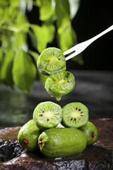 Fresh Dandong Kiwi Fruit on Fork Showing Soft Green Flesh and Vitamins Rich Tropical Food