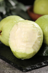 Fresh Guava Fruit Heart-Shaped Cross Section from Guangxi China on Dark Slate Board