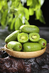 Fresh Kiwi Fruits in Wooden Bowl with Water Droplets Showing Natural Freshness and Vibrant Green Colors