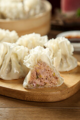 Handmade Chinese Dumplings with Meat Filling on Wooden Board - Traditional Asian Cuisine