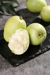 Fresh Guangxi White Guava Fruits with Soft Heart-Shaped Flesh on Slate Board