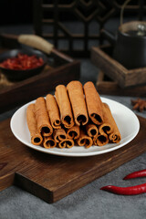 Natural Cinnamon Sticks on White Plate - Aromatic Spice Display for Cooking and Baking