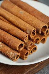 Natural Guangxi Cinnamon Sticks Spice Seasoning Bark on White Plate