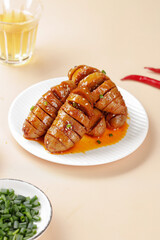 Homemade Henan Gluten Skewers in Savory Sauce - Traditional Chinese Street Food on White Plate