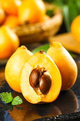 Fresh Loquat Fruit from Yunnan China - Traditional Asian Alpine Fruit Cut in Half Showing Seeds and Orange Flesh