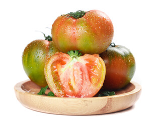Fresh Heirloom Tomatoes with Water Drops on Wooden Plate - Organic Vegetables