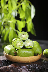 Fresh Kiwi Berry Fruit with Refreshing Pulp and Natural Vitamins in Wooden Bowl