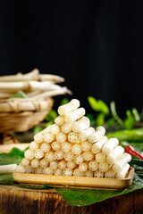 Fresh Lotus Root Vegetable Display on Bamboo Tray with Green Leaves - Traditional Asian Cooking Ingredient
