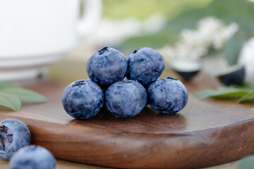 Fresh Organic Blueberries on Wooden Board - Healthy Superfood Antioxidant Berry Nutrition