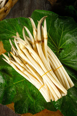 Fresh Bamboo Shoots Bundle on Green Leaves - Organic Asian Vegetables Ready for Cooking