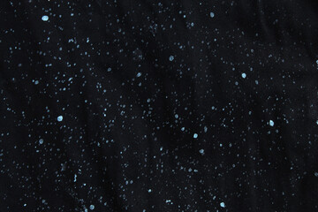 black fabric texture with blue paint stains