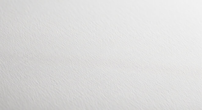 Angled view of white paper background with fine texture and perspective, empty bright surface of premium cardstock for elegant design or professional mockup template for website