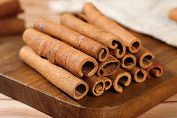 Natural Cinnamon Bark Sticks from Guangxi on Wooden Board - Aromatic Cooking Spice