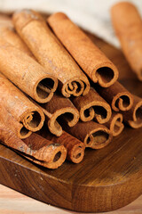 Natural Cinnamon Sticks Rolls Spice Seasoning on Wooden Board