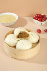 Handmade Pork Buns in Bamboo Steamer with Soup and Cherry Tomatoes Traditional Asian Cuisine