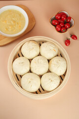 Handmade Steamed Pork Buns with Scallion in Bamboo Steamer and Dipping Sauce