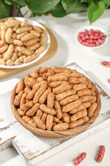 Fresh Shelled Peanuts and Red Skinned Nuts in Wooden Bowls on White Rustic Background
