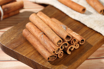 Natural Cinnamon Bark Sticks on Wooden Board - Aromatic Spice Seasoning Ingredient