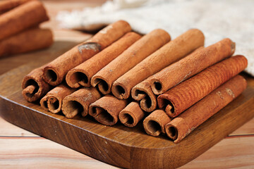 Natural Cinnamon Sticks from Guangxi China on Wooden Board - Aromatic Cooking Spice
