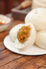 Handmade Pork and Scallion Steamed Buns Traditional Asian Dim Sum on Wooden Table