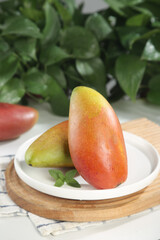Fresh Ripe Mango Slices with Golden Red Skin on Wooden Board - Tropical Fruit Ready to Eat