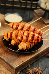 Spicy Handmade Gluten Skewers from Henan China on Wooden Board with Sauce