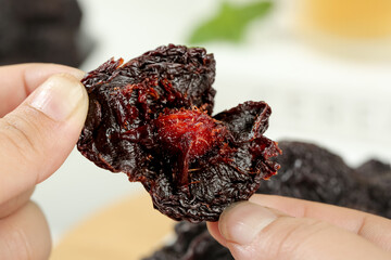 Dried Hibiscus Fruit in Hand - Natural Candied Plum-Like Healthy Snack Food Ingredient