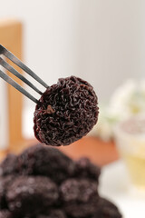 Dried Candied Plum Fruit Traditional Chinese Snack Held with Chopsticks