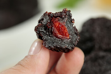 Chinese Candied Dried Plum Fruit Traditional Yongtai Preserved Snack Food in Hand