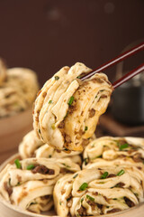 Handmade Asian Noodles with Scallions and Meat Lifted by Chopsticks - Traditional Cooking Food Photography