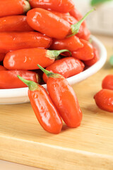 Fresh Red Goji Berries Wolfberries from Ningxia China in Bowl on Wooden Board